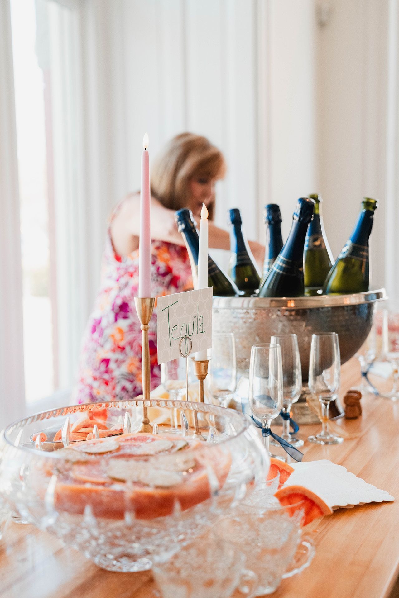 A group of women are posing for a picture in front of a wall of pink balloons.