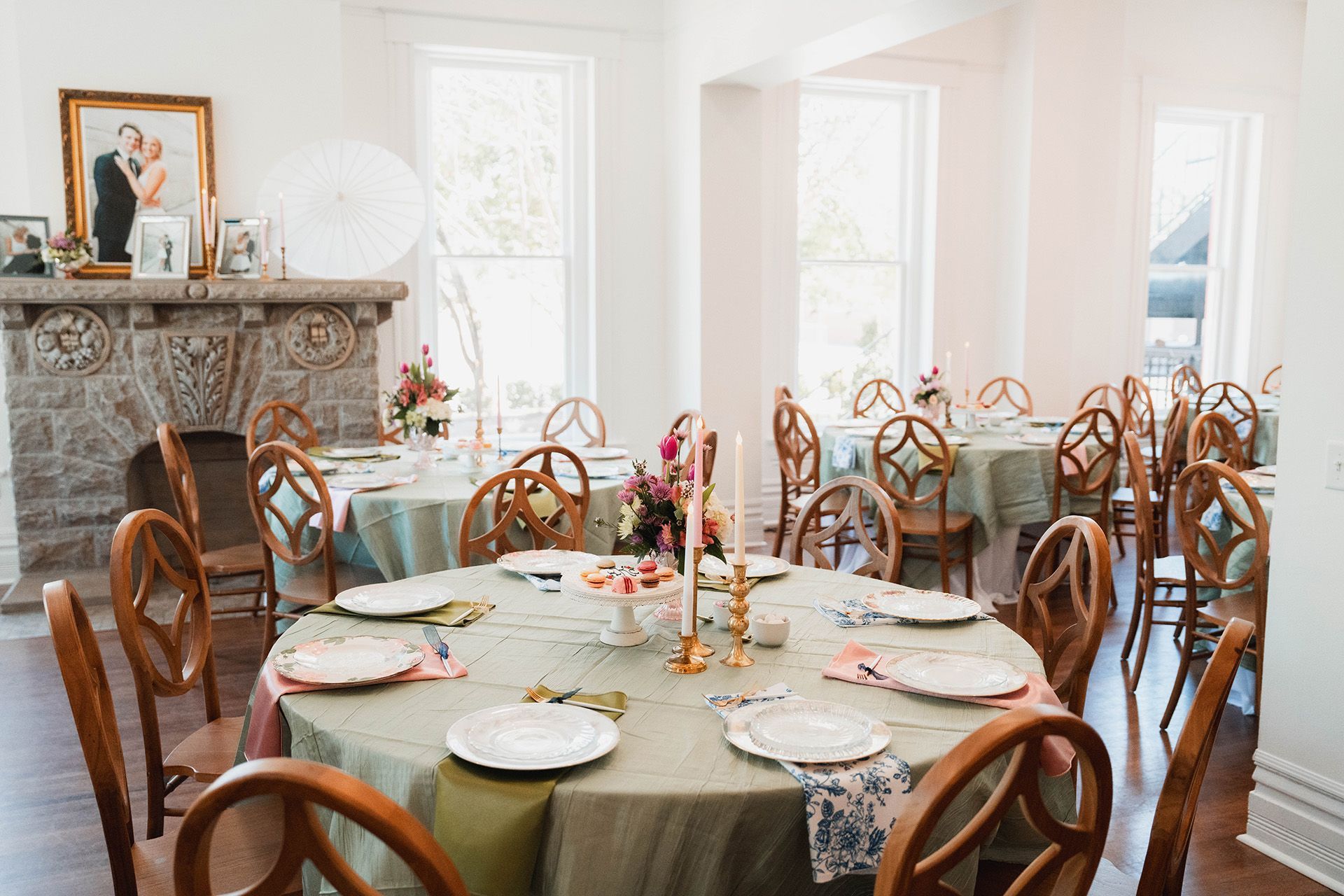 A large room with tables and chairs set up for a wedding reception.