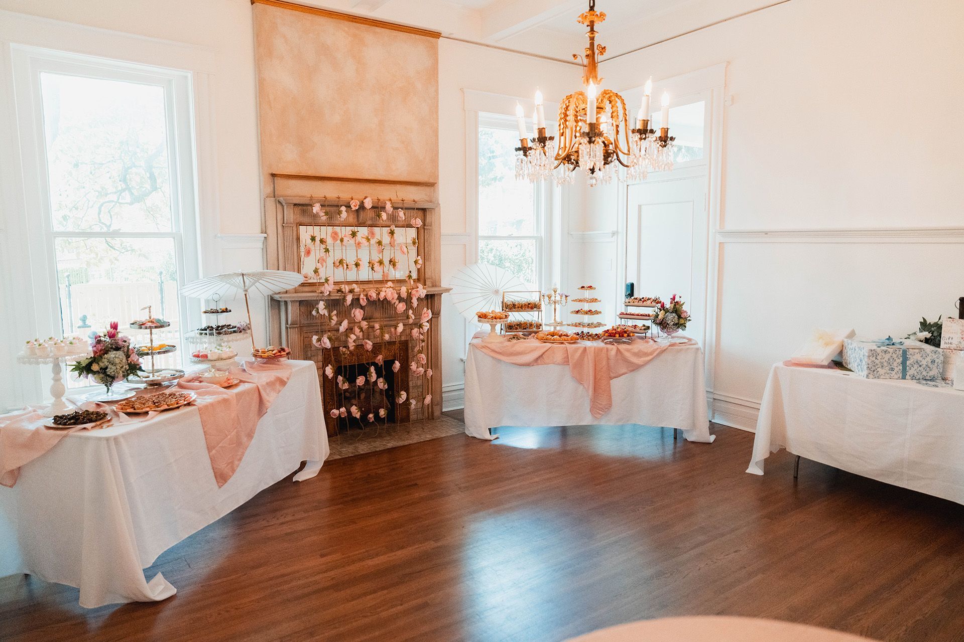 A room filled with tables and a fireplace.