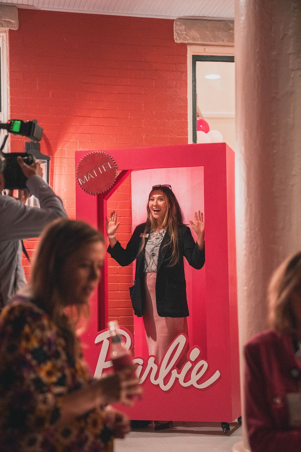 A woman is standing in a barbie box.