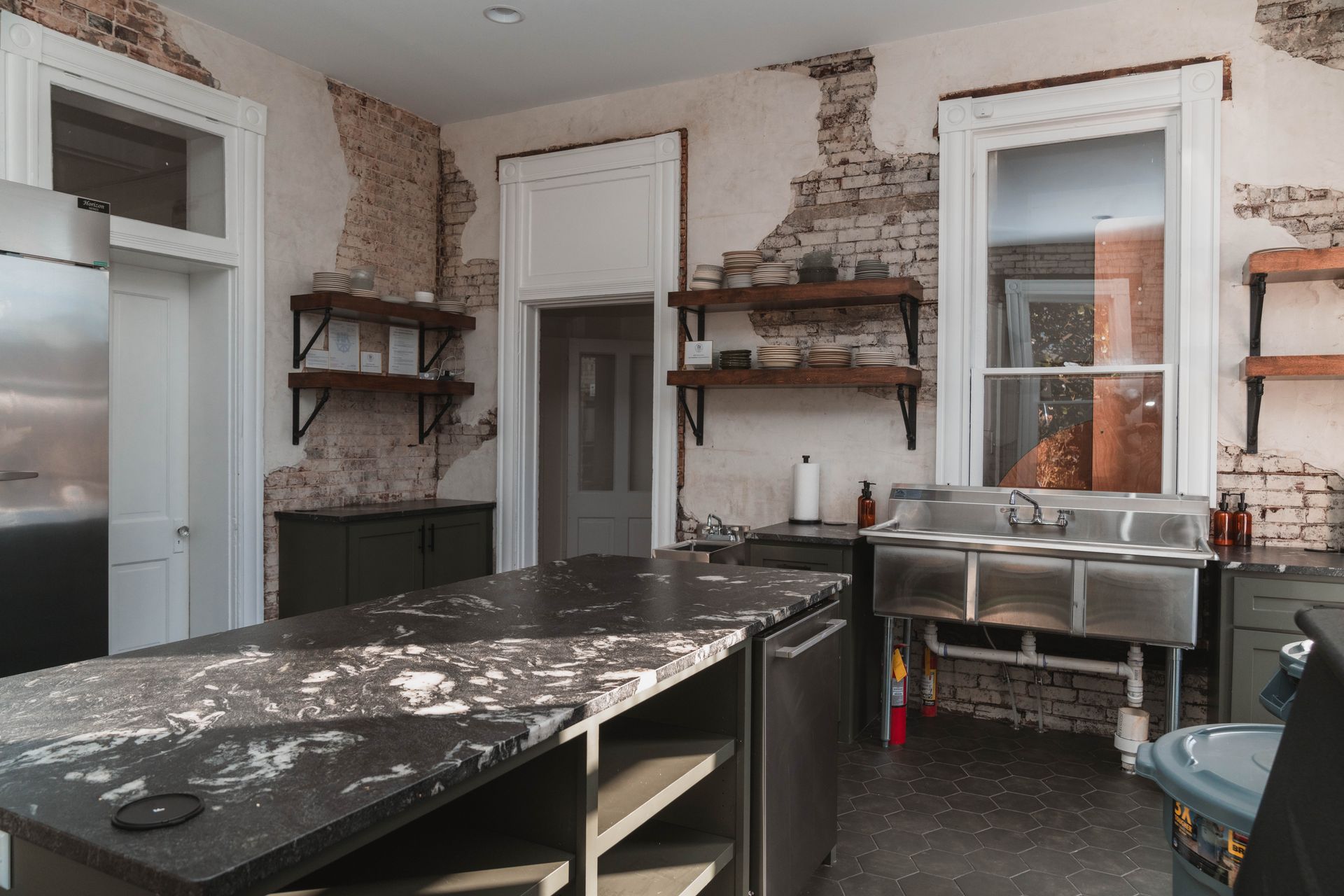 A kitchen with a large island and stainless steel appliances.