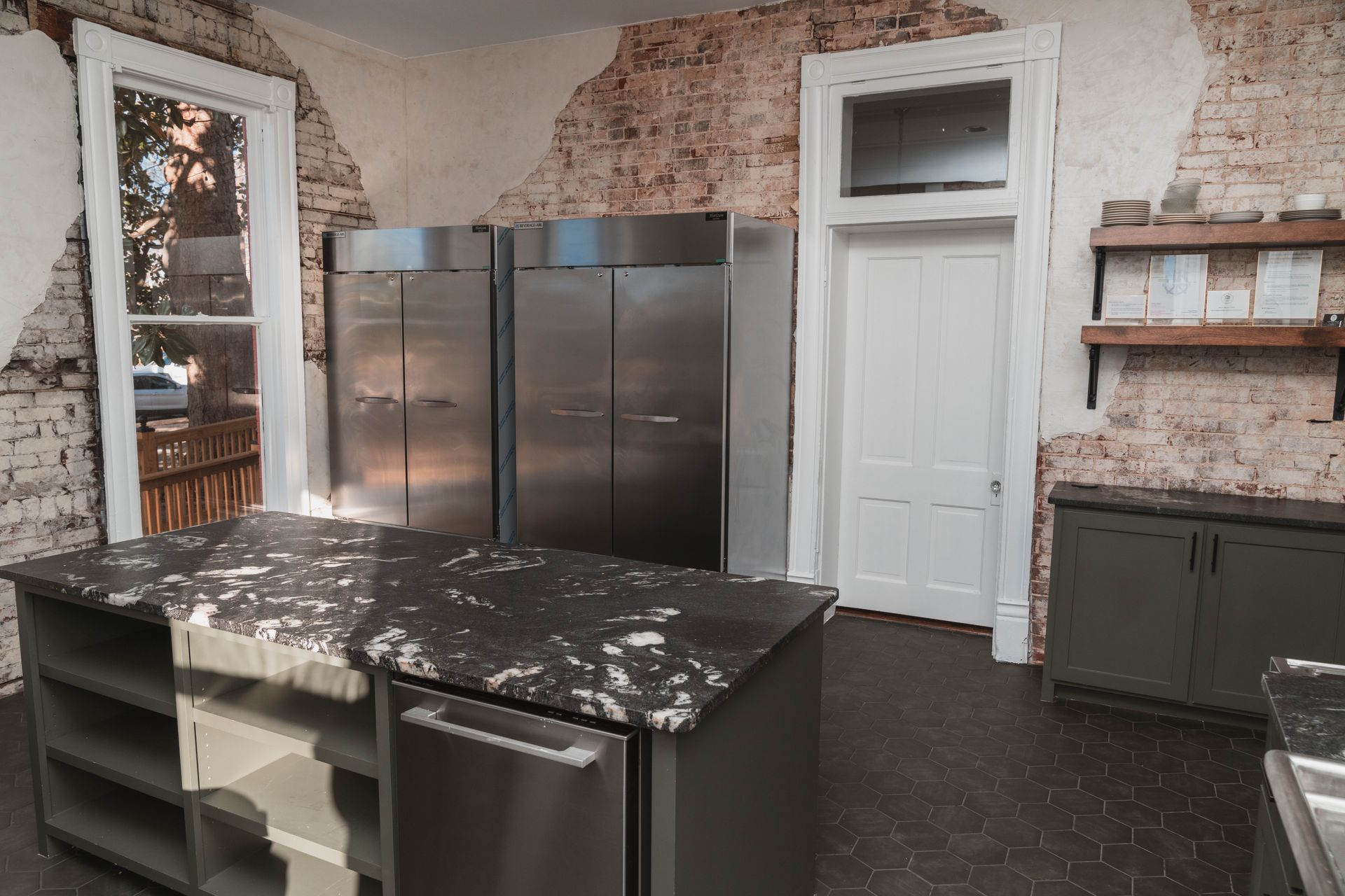 A kitchen with a large island and stainless steel appliances