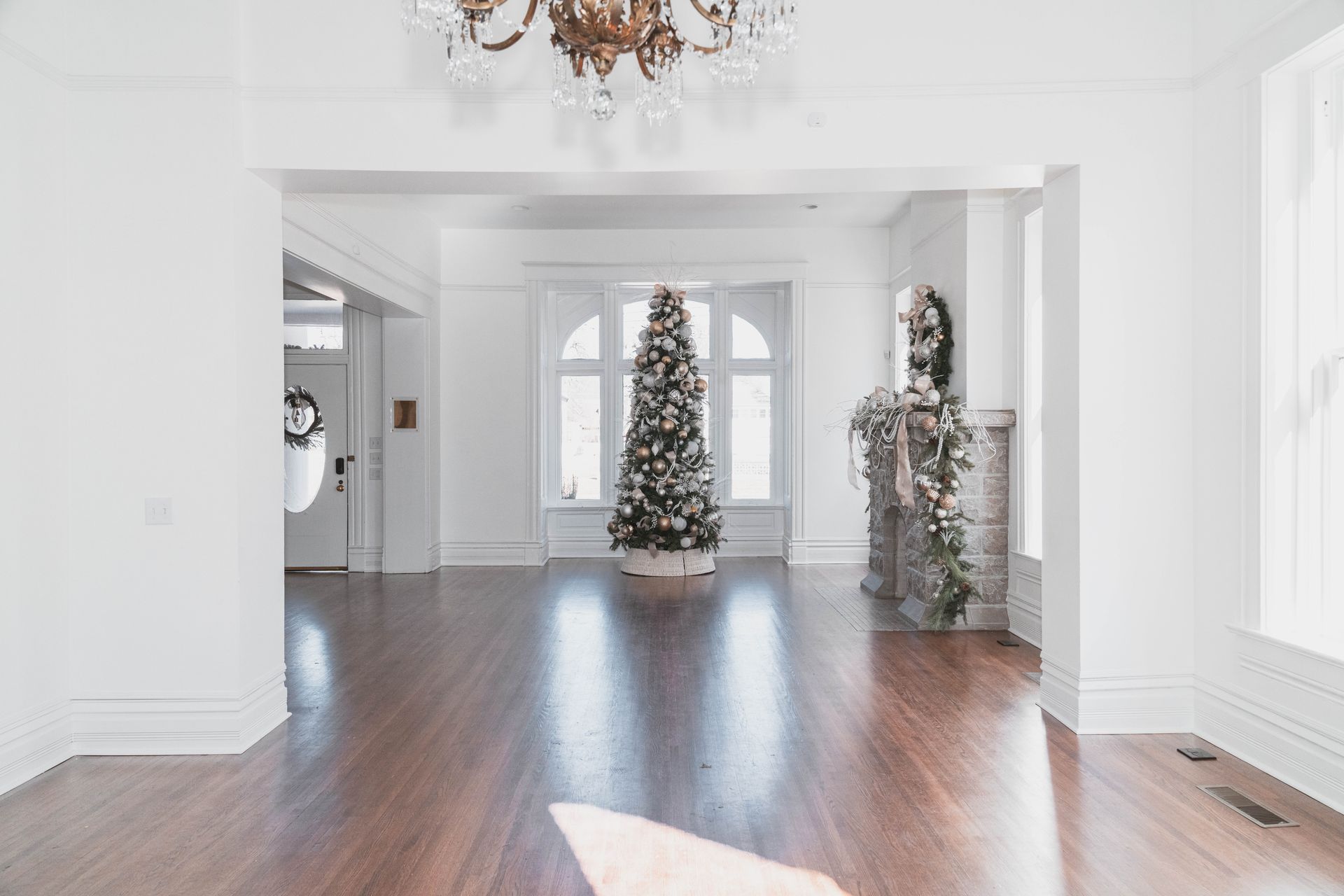 There is a christmas tree in the middle of the room.