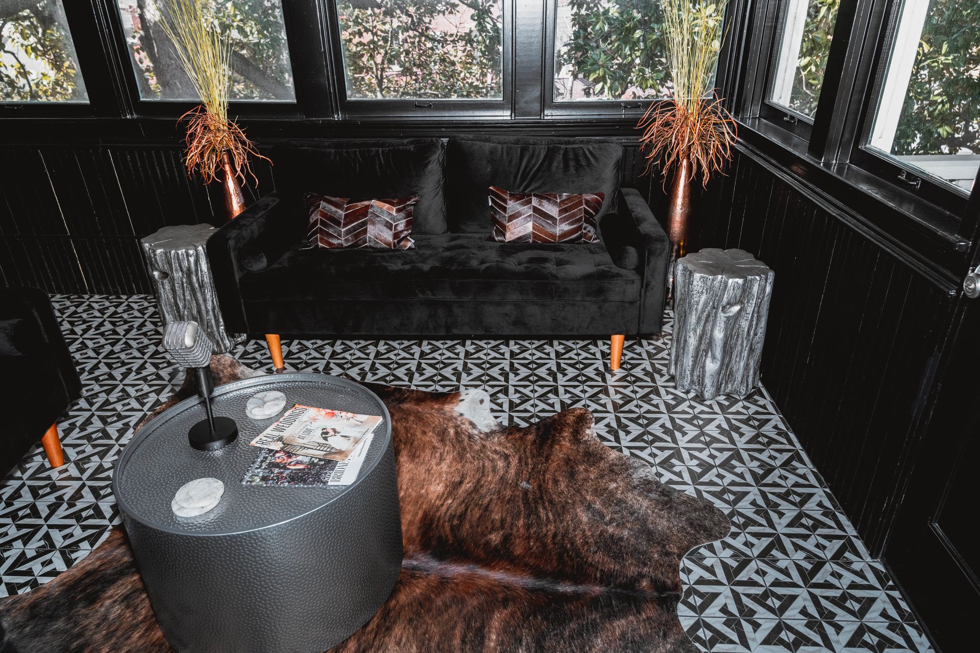 A living room with a couch , table , and rug