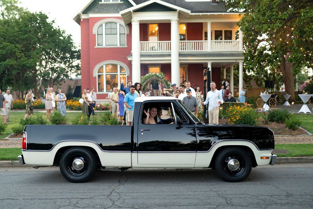 Newly married couple leaving E.O. Manees house in antique truck