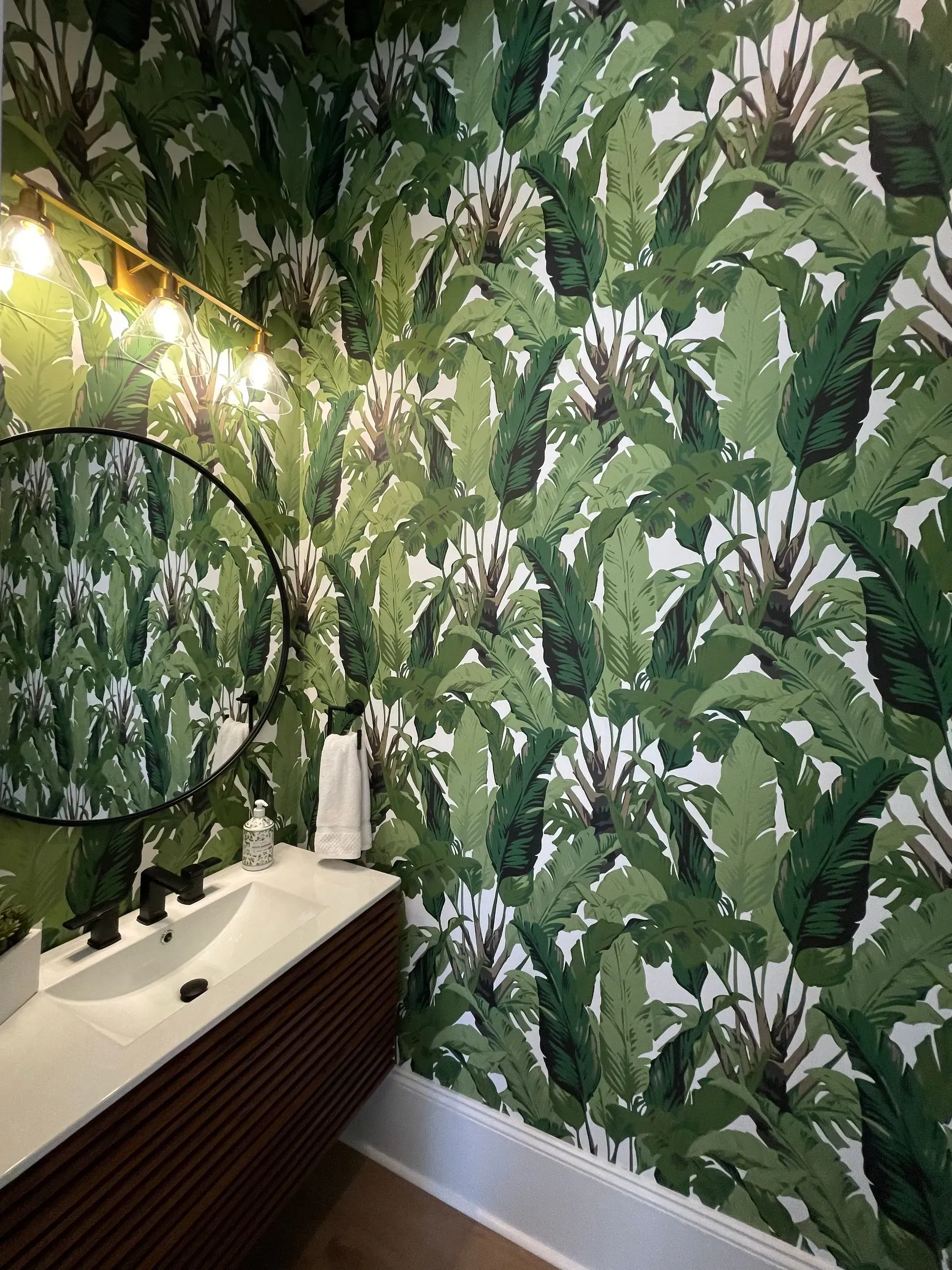 A yellow excavator is sitting on top of a pile of gravel.