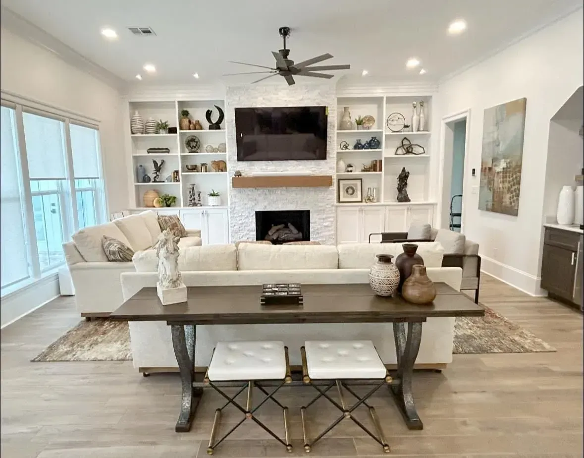 A living room with a couch , table , fireplace and television.