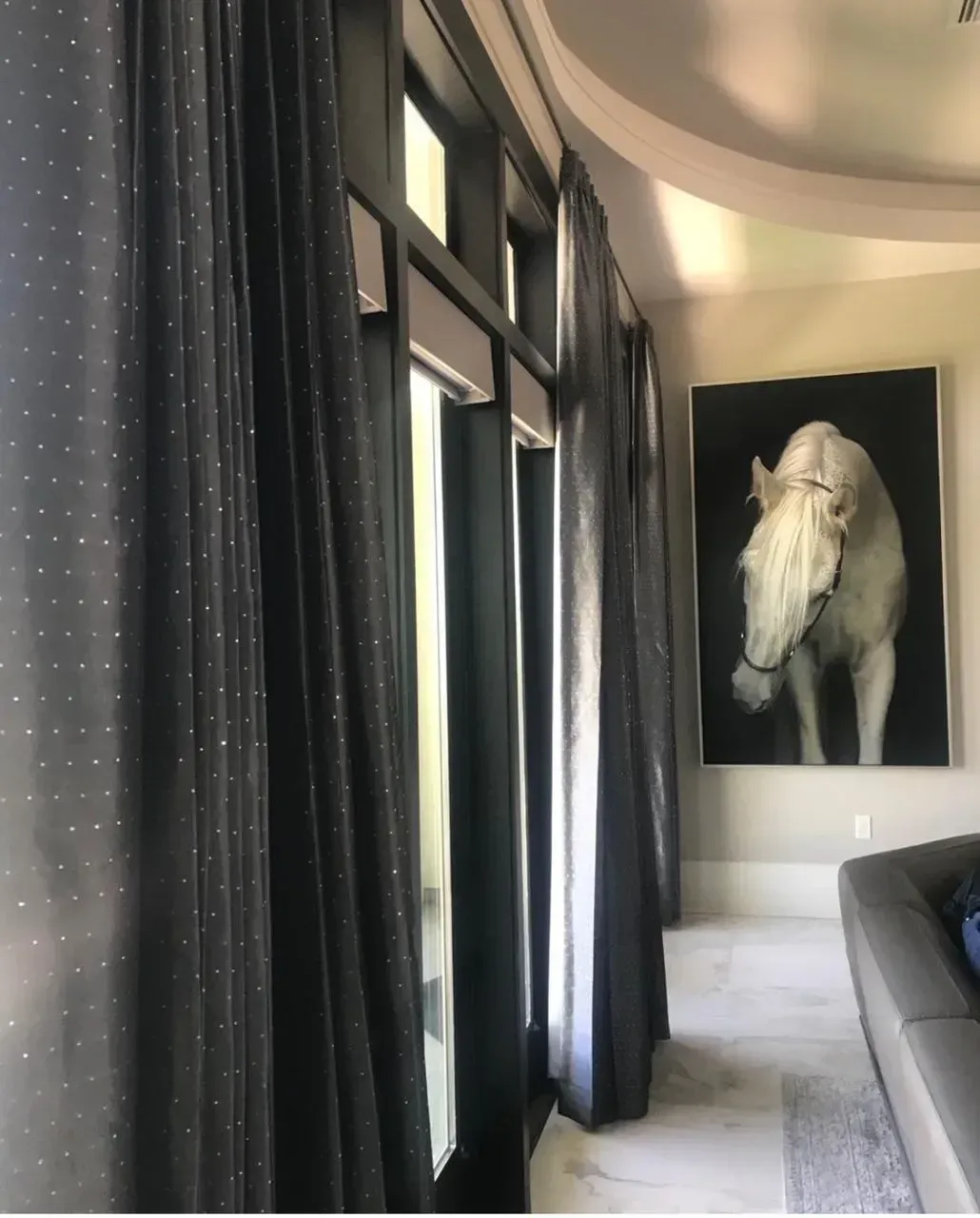 A room with a picture of a horse on the wall