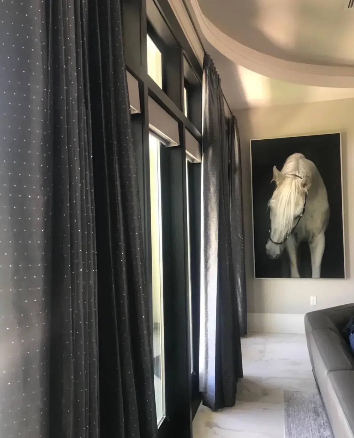 A man wearing a hard hat and goggles is standing in a room.