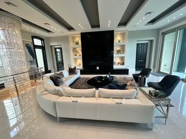 A living room with a couch and chairs and a fireplace