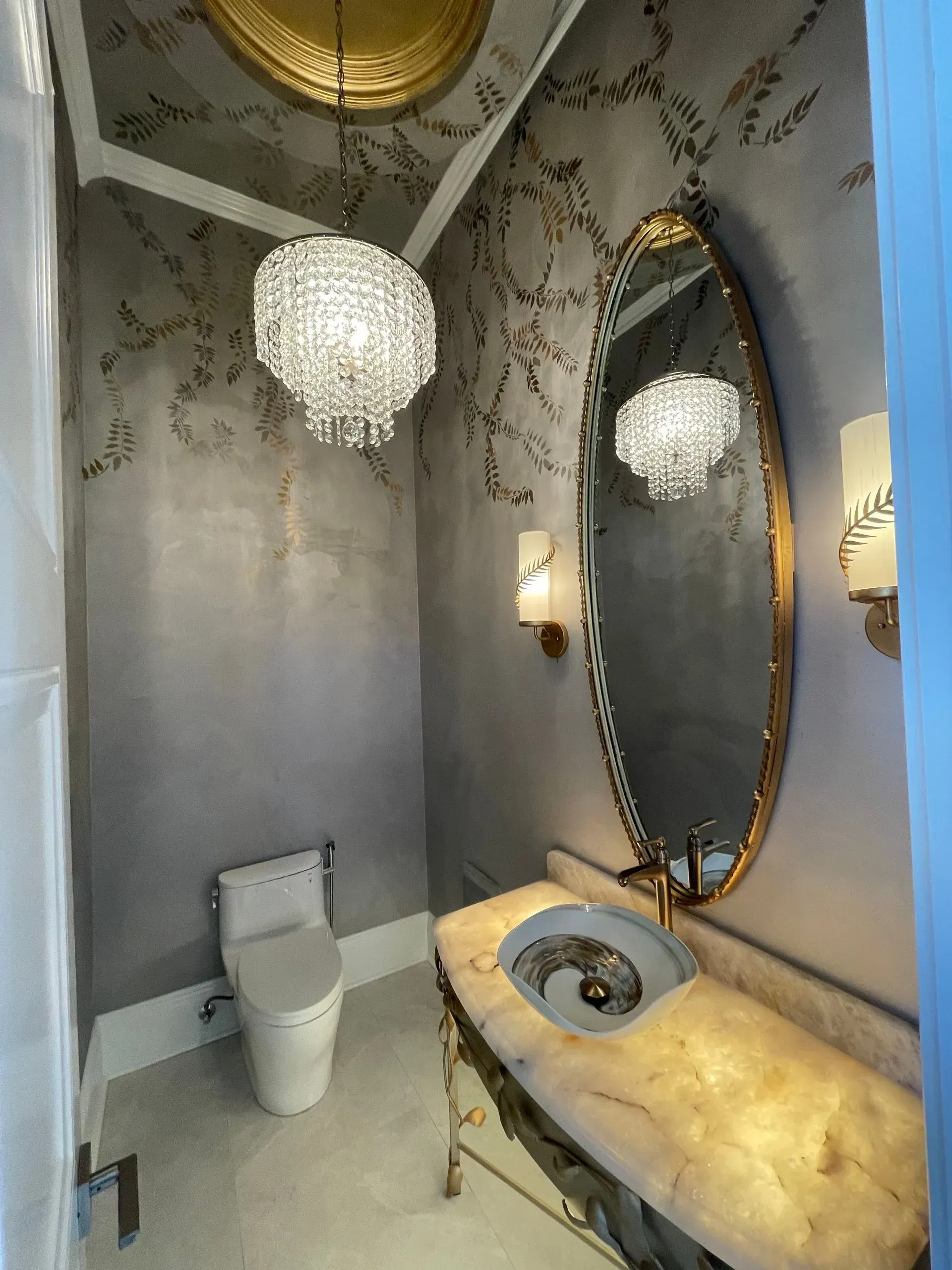 A bathroom with a toilet , sink and mirror