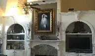 There is a painting of a horse on the wall above the fireplace.