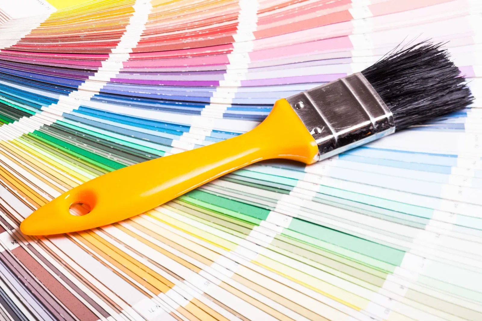 A yellow excavator is sitting on top of a pile of gravel.