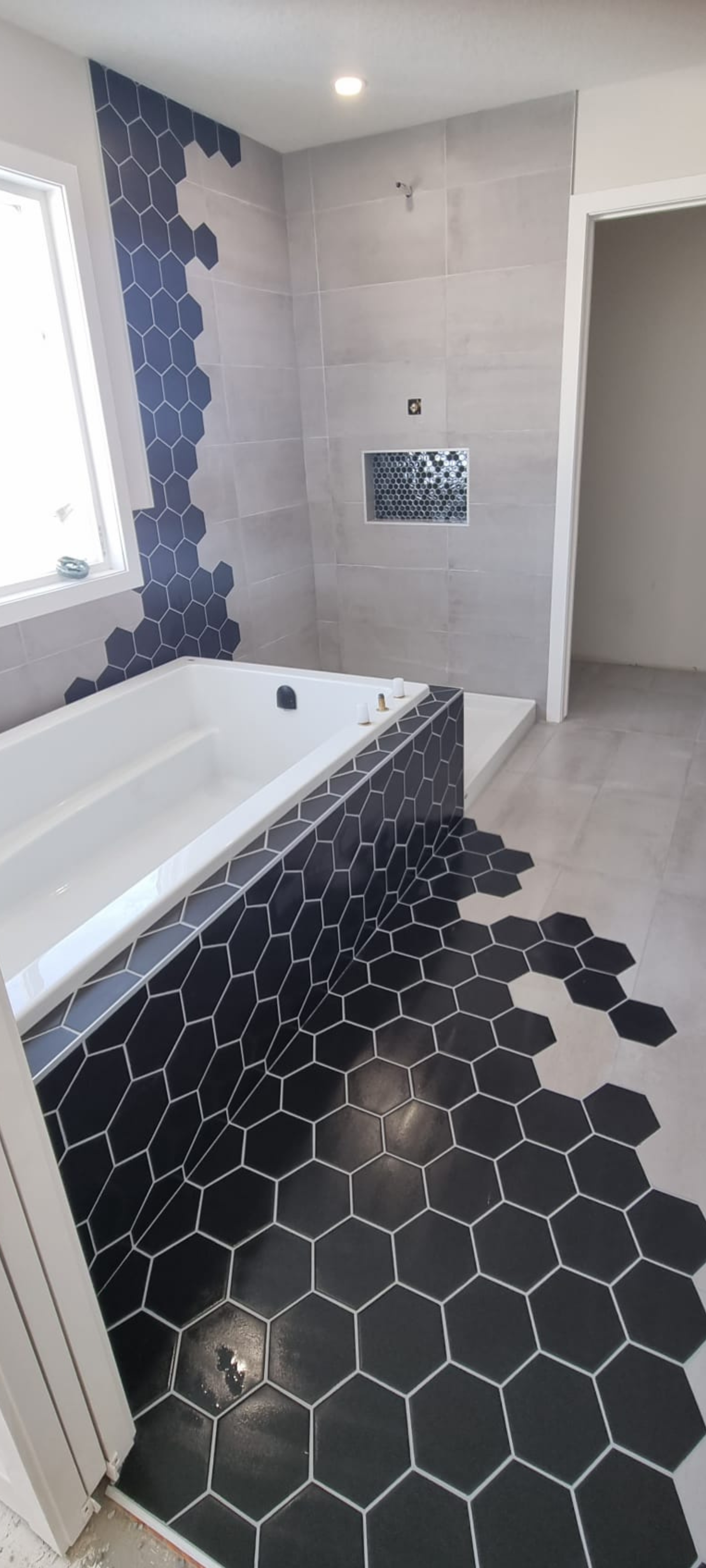Modern hexagon tile installed by XMP Construction in Sherwood Park bathroom.