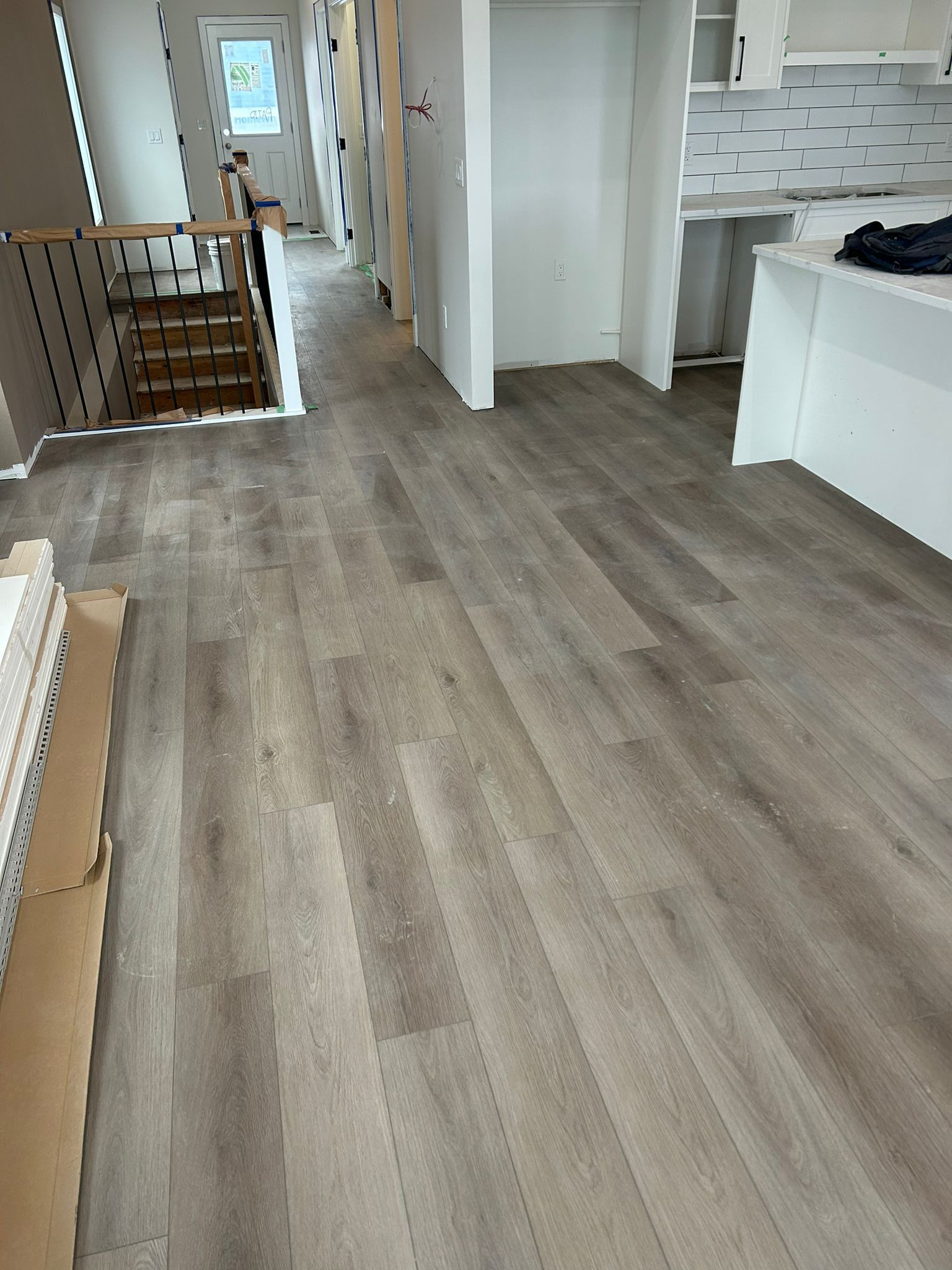 Light grey luxury vinyl plank flooring installed throughout a Sherwood Park home by XMP Construction.