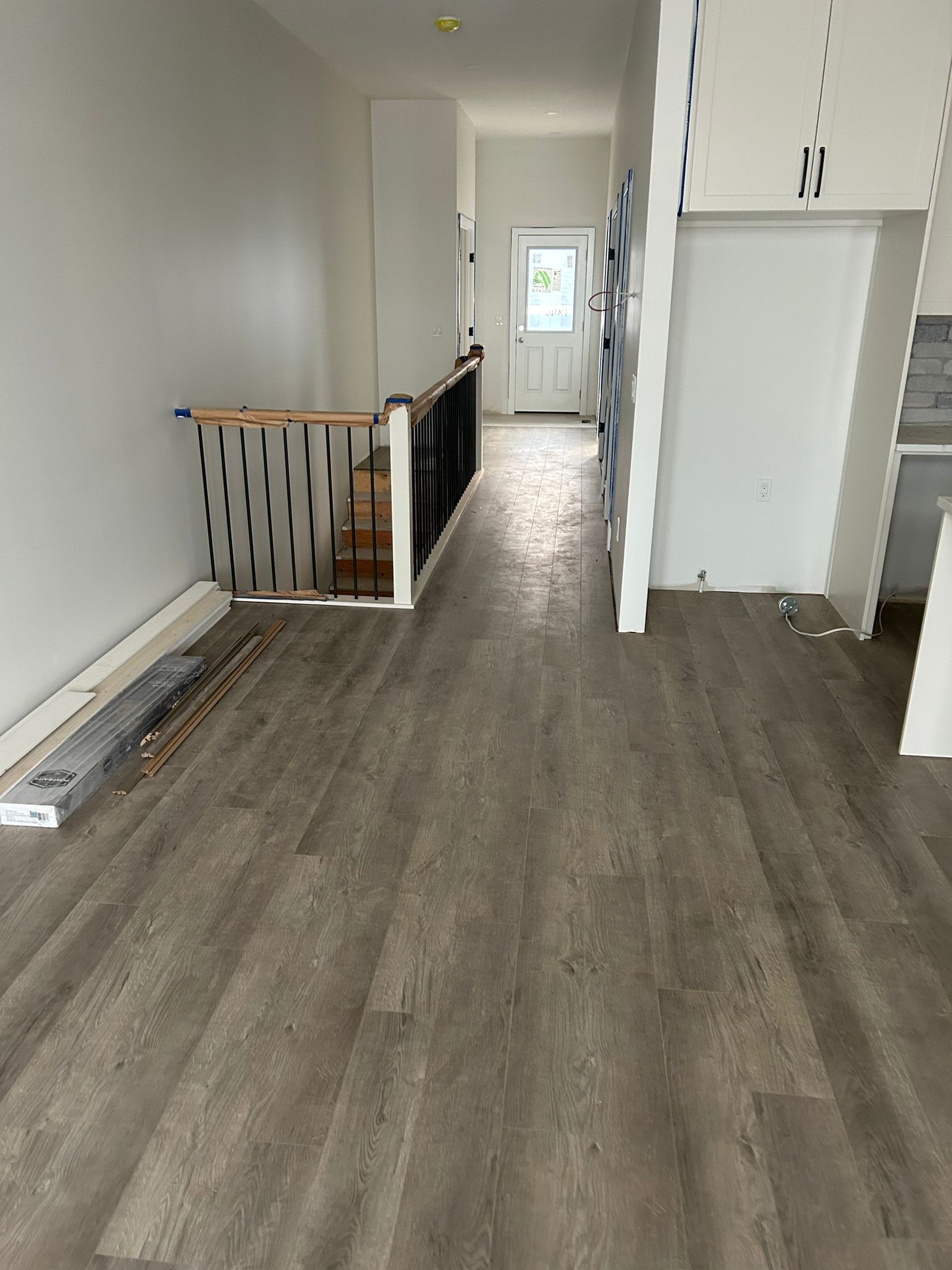 Light grey luxury vinyl plank flooring installed in a Sherwood Park home by XMP Construction.