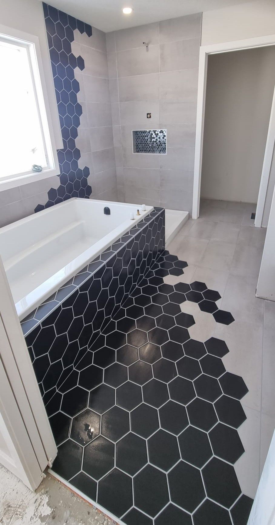 Modern bathroom tile installation, combining different tile shapes and sizes.