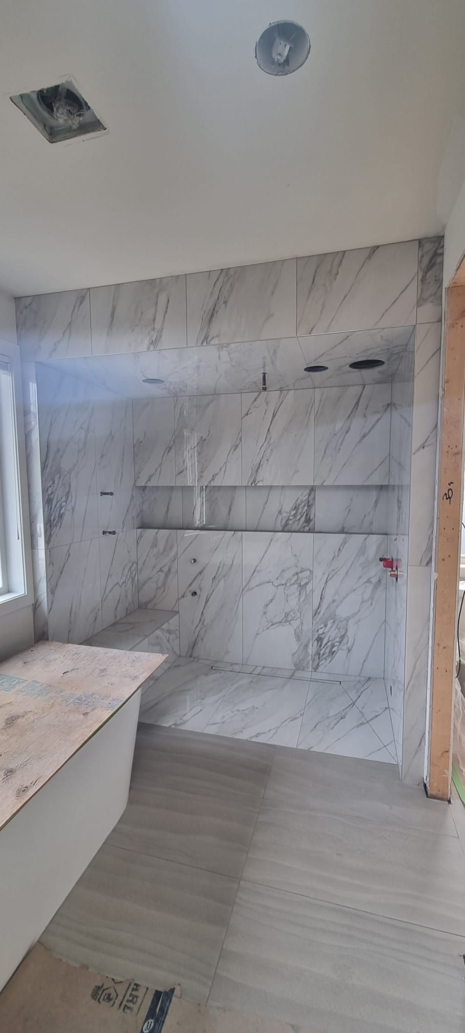 Porcelain tile flooring in a Sherwood Park bathroom renovation by XMP Construction.