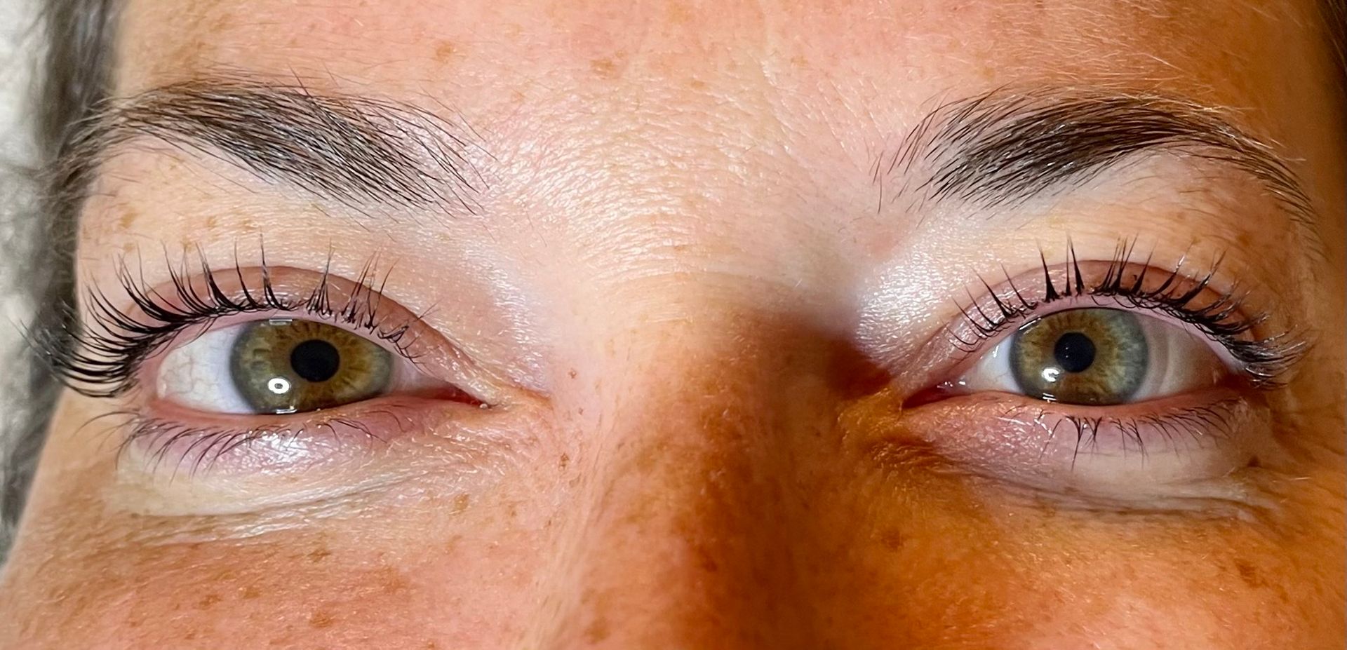 a close up of a person 's eyes before & after lash lift