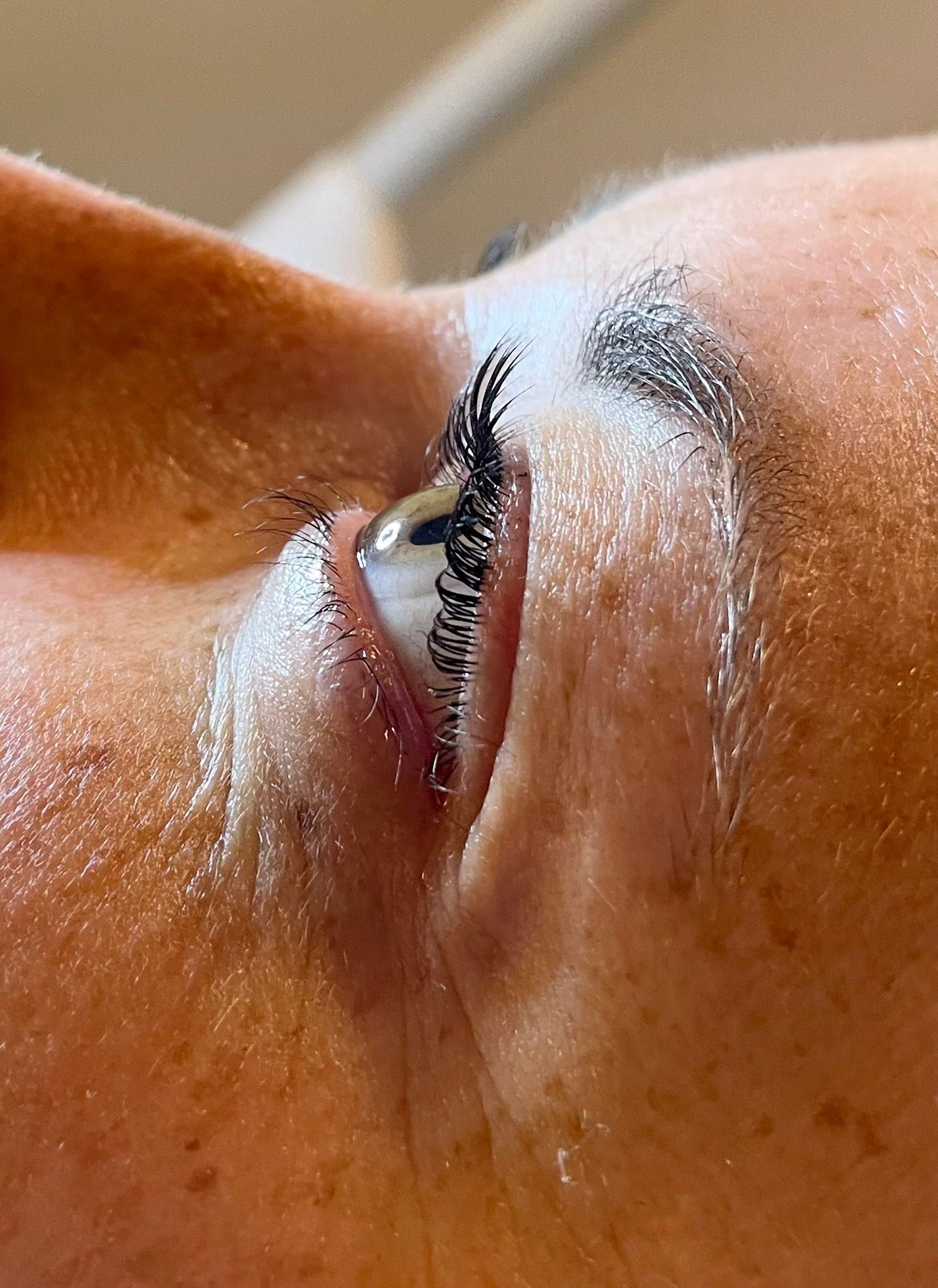 a close up of a woman 's eye with long eyelashes