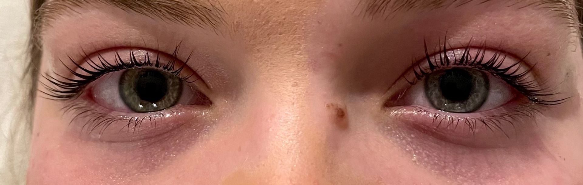 a close up of a woman 's eyes with long eyelashes