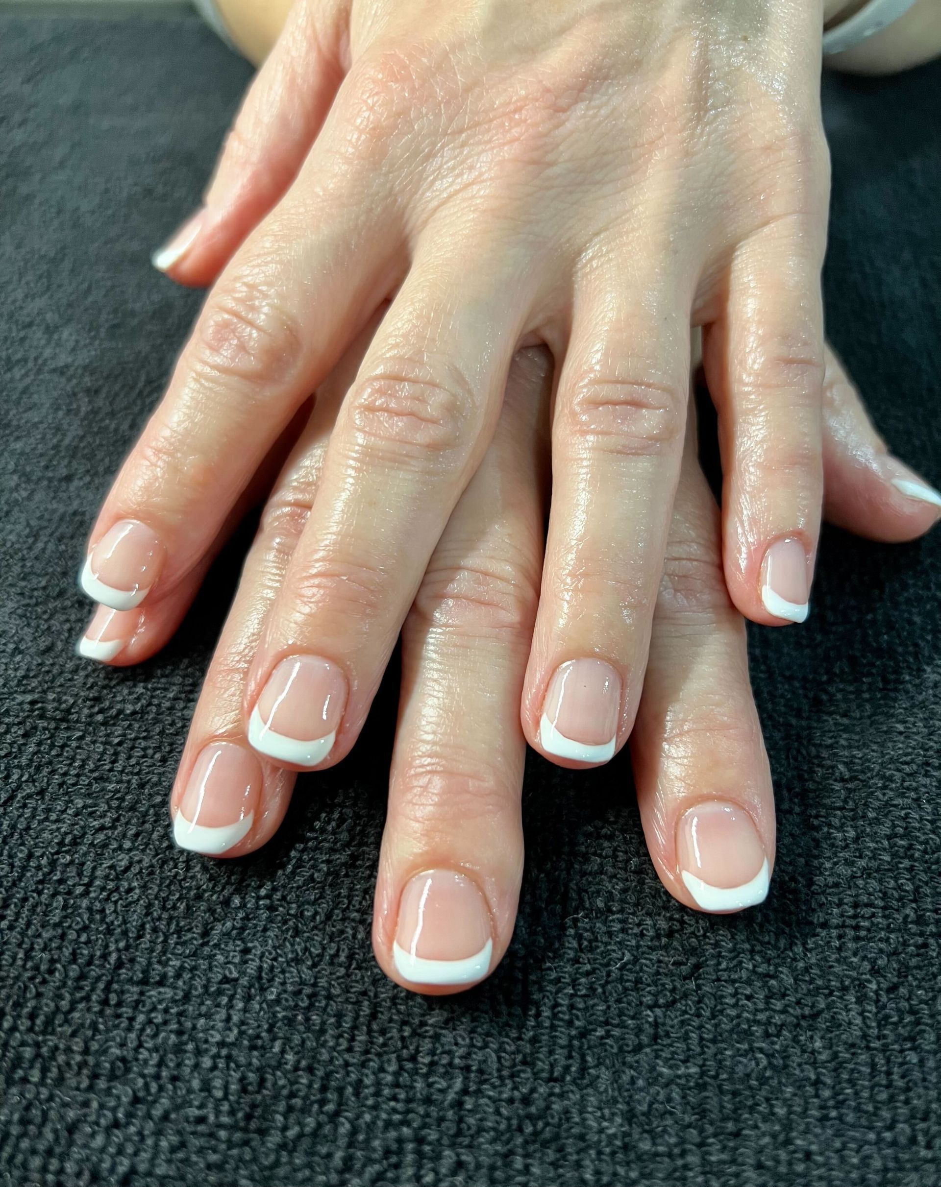 a close up of a woman 's nails with a leaf design
