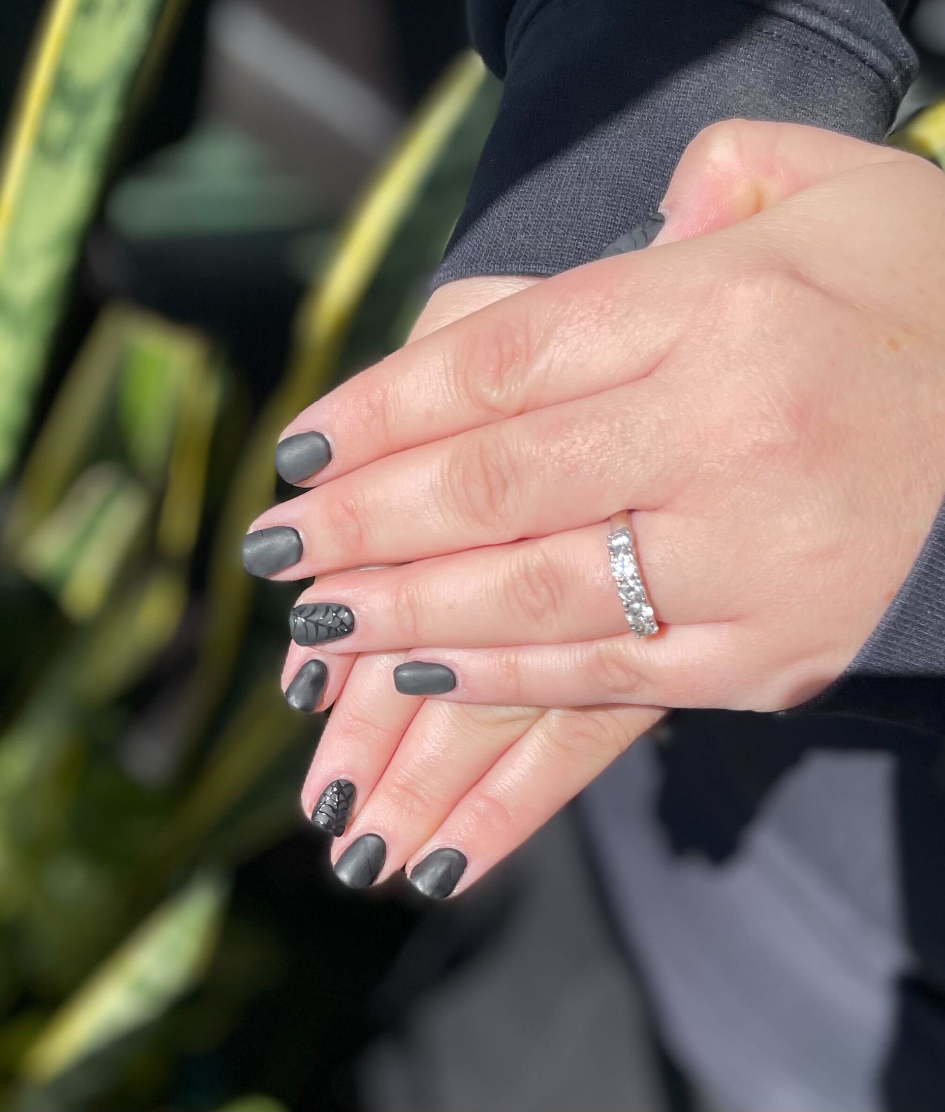 a close up of a woman 's hand with a ring on it