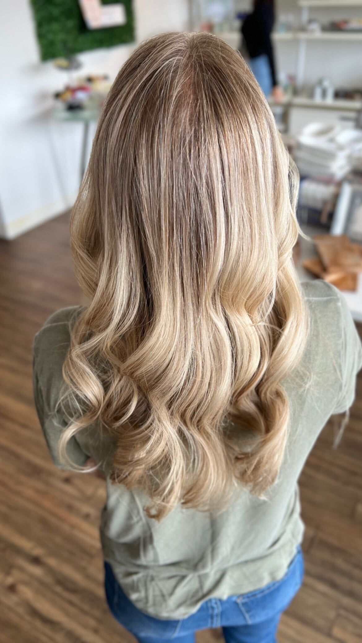 a woman with blonde hair is wearing a green shirt