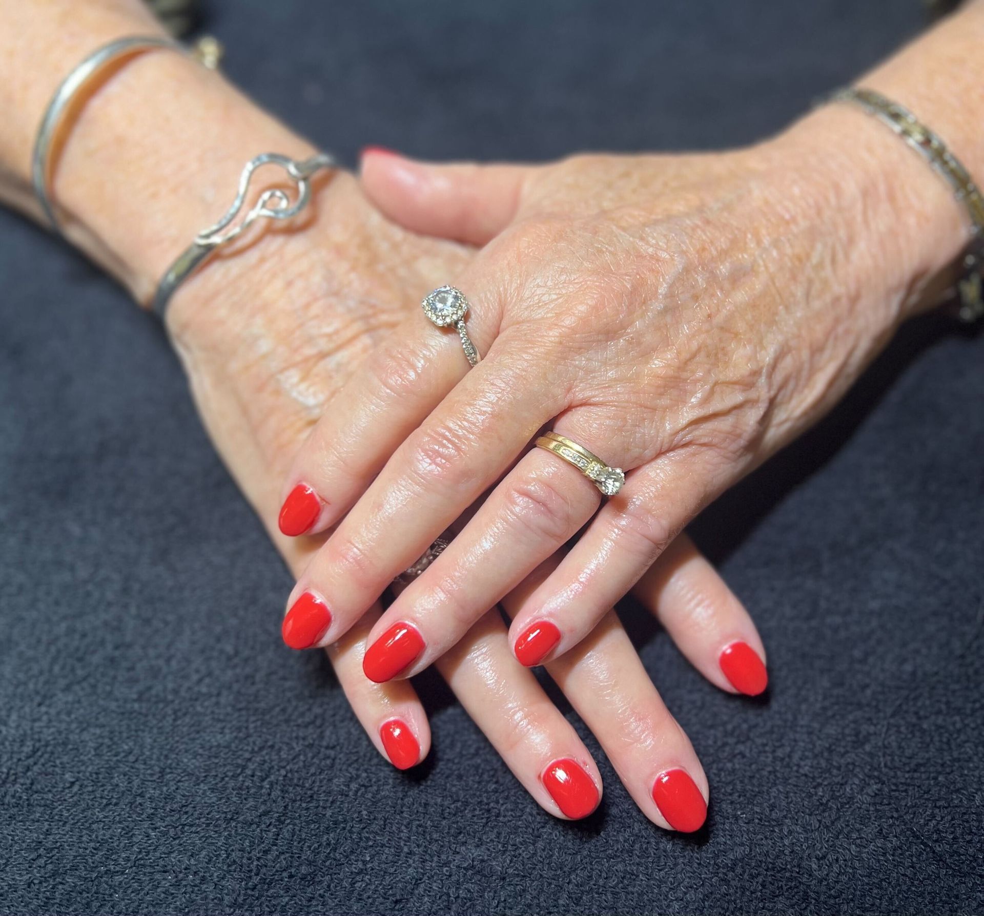 a close up of a woman 's hands with red nails