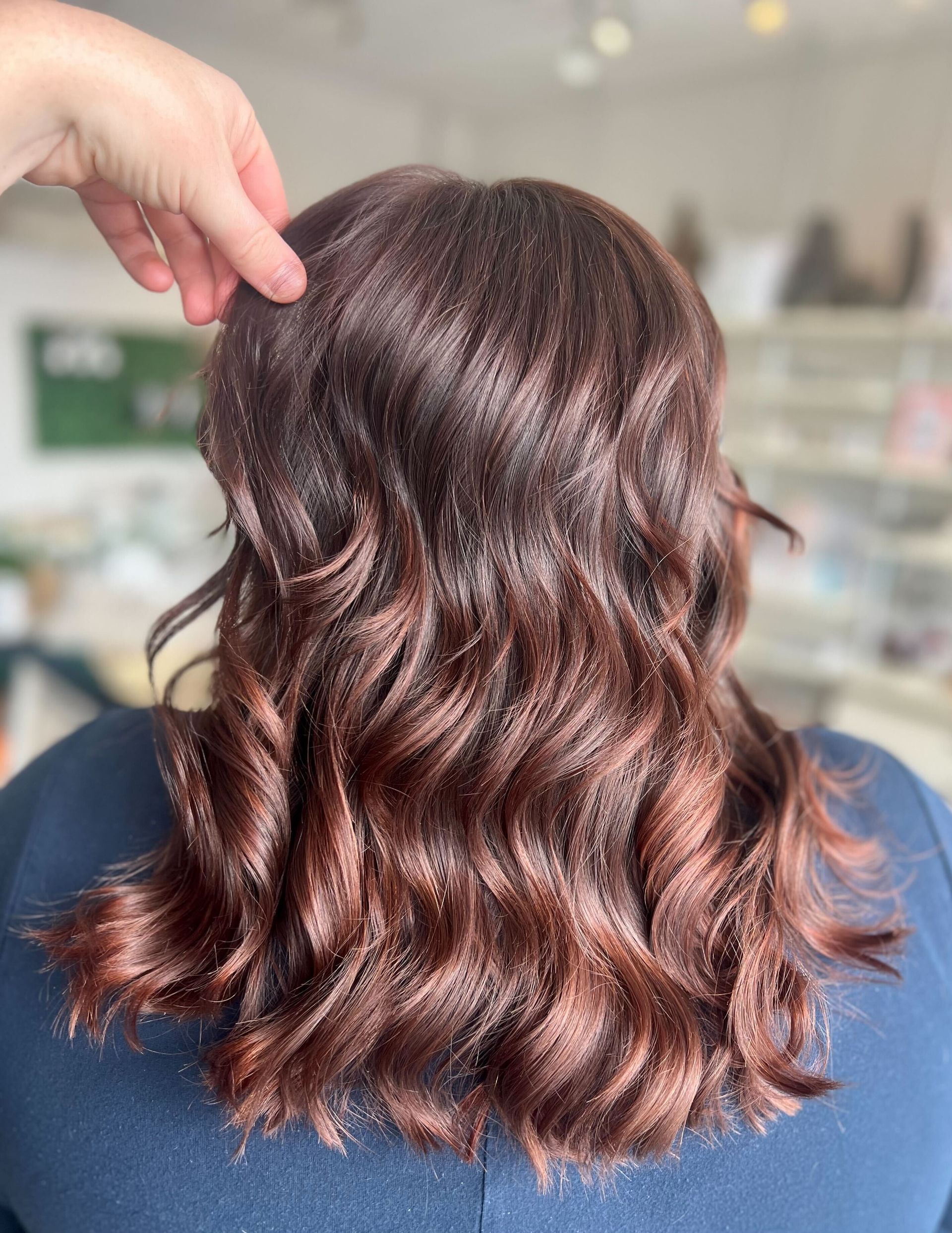 a woman 's hair is being touched by a person