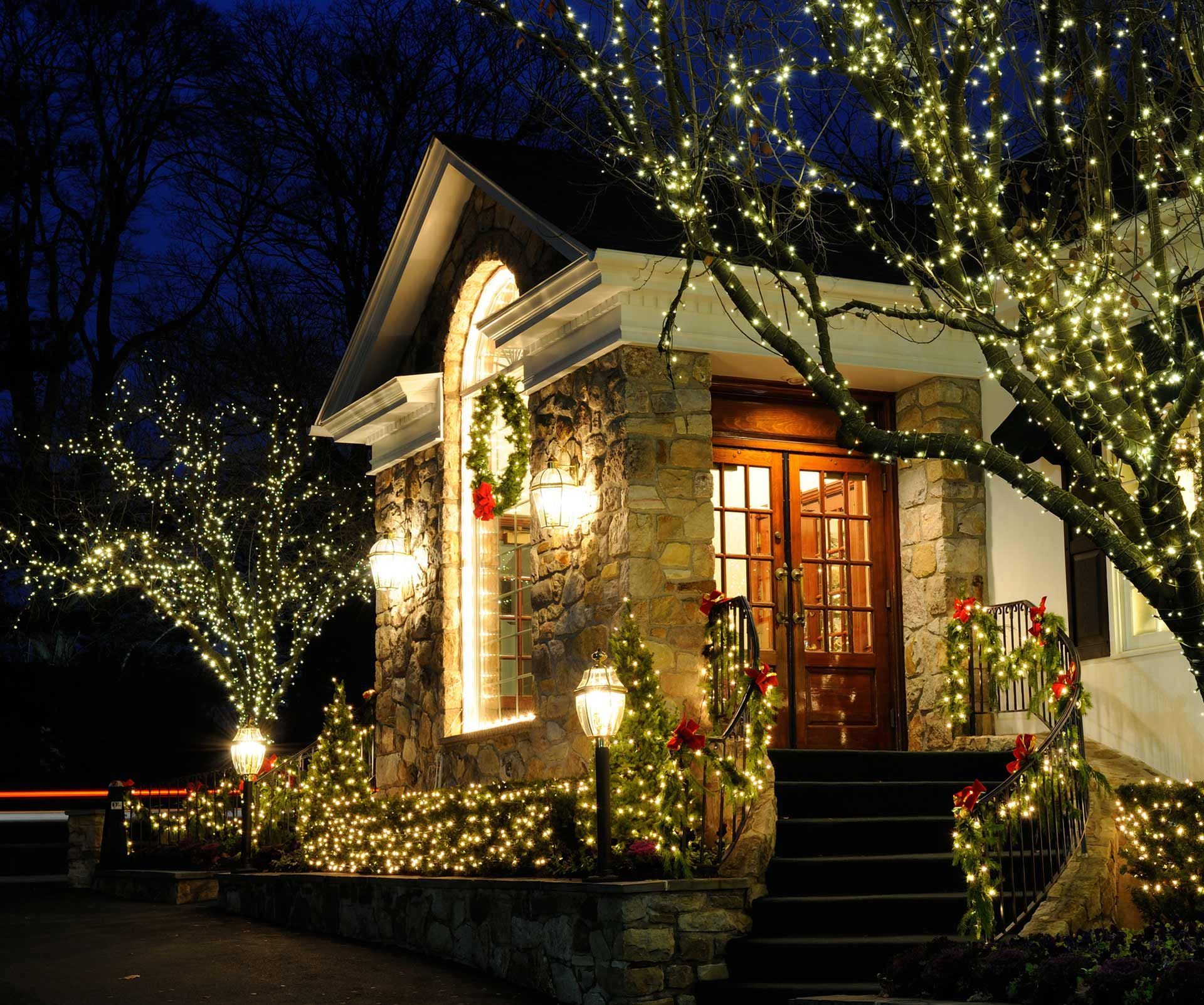 A house is decorated with Christmas lights at night