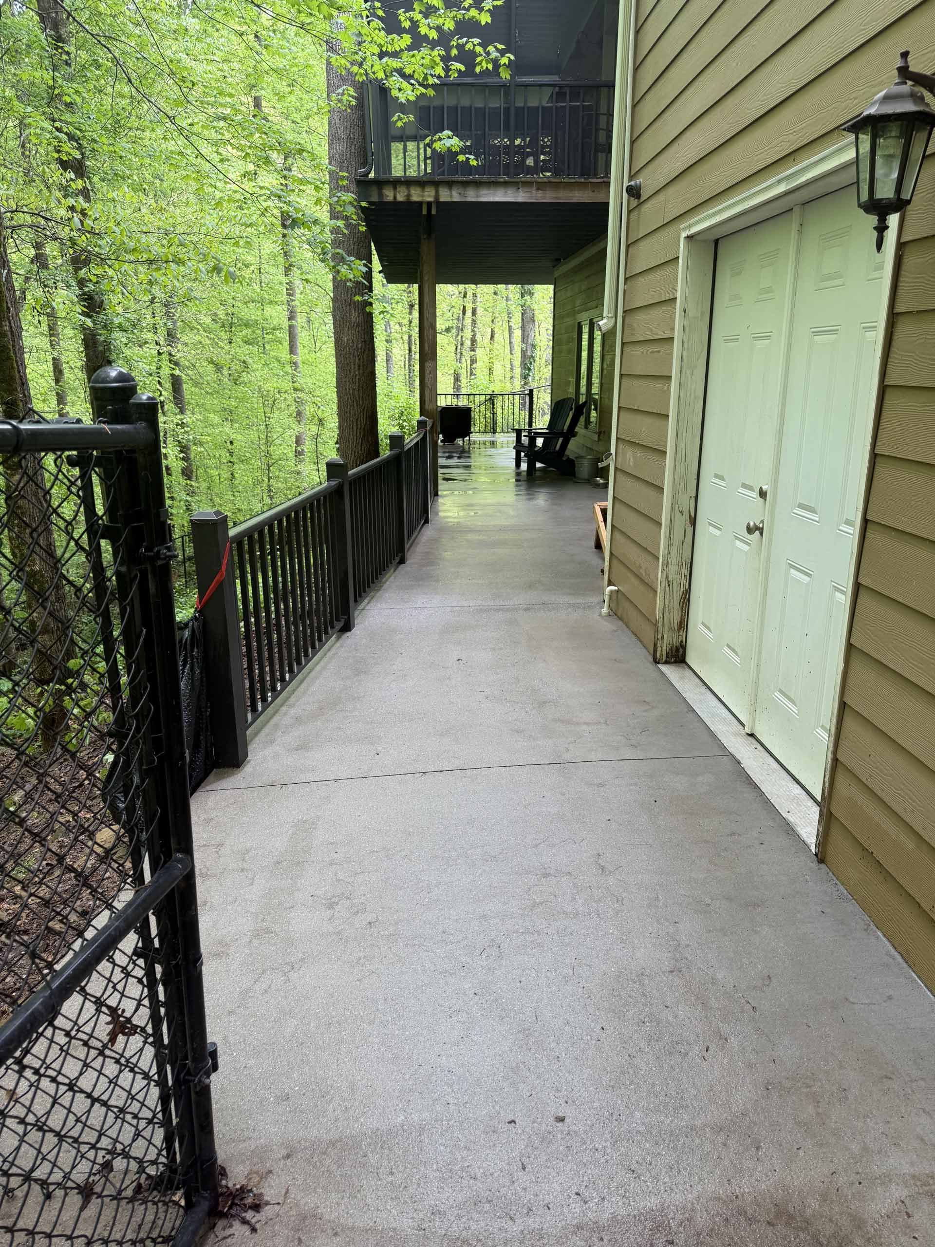 A walkway leading to a house with a garage door