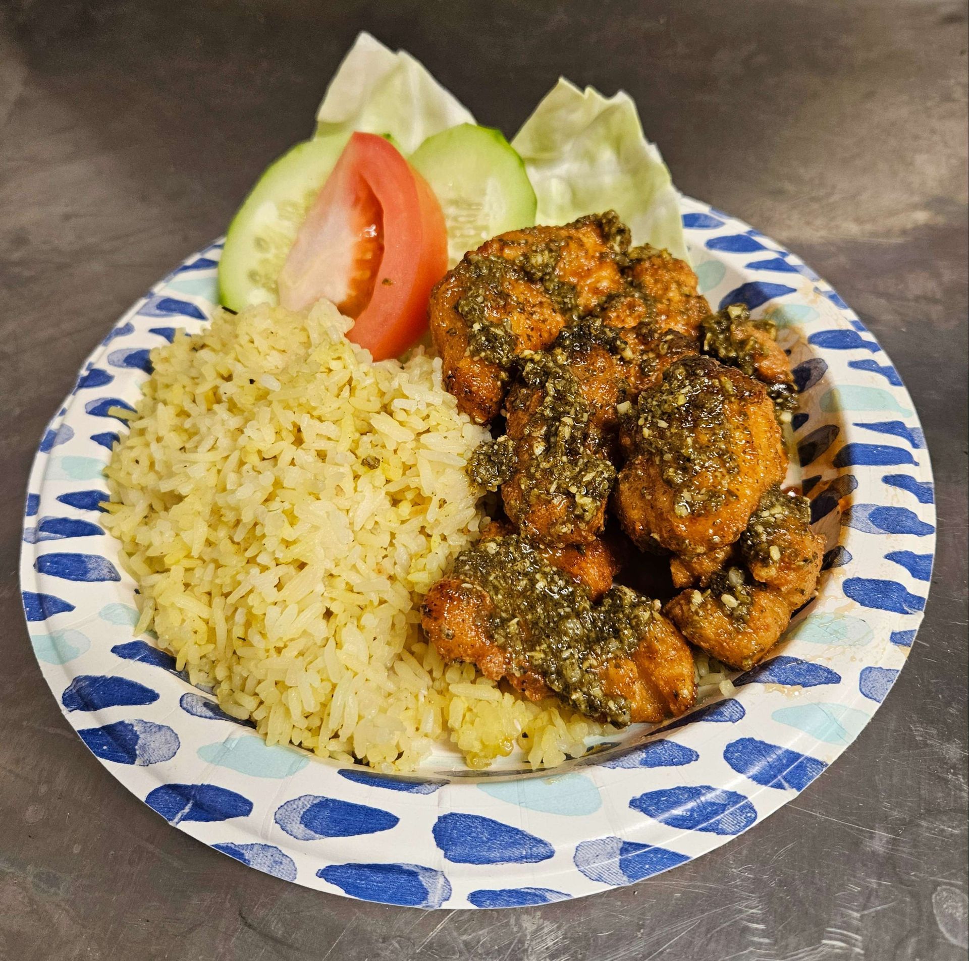 A plate of food with rice and vegetables on a table