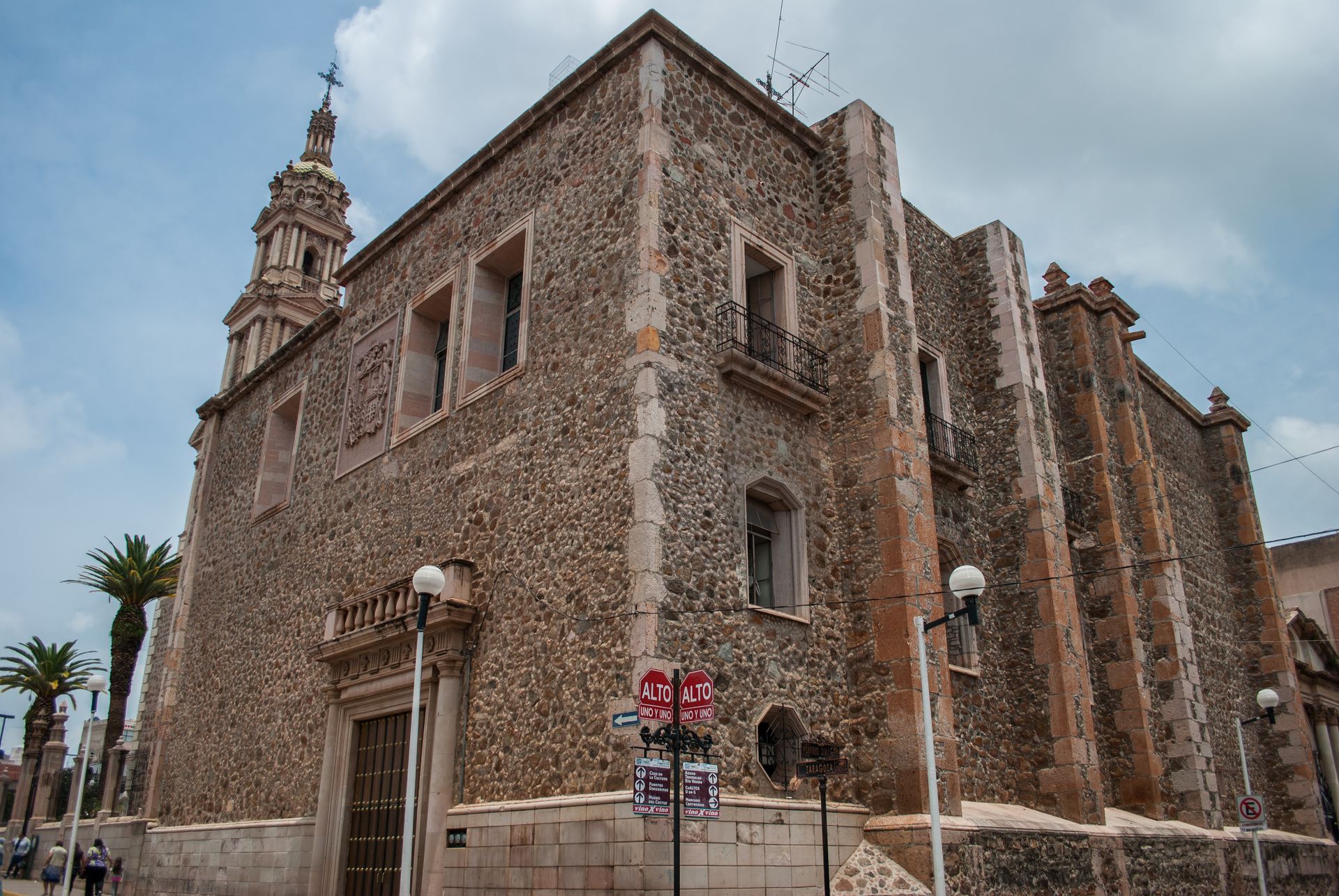 a large stone building with a cross on top of it