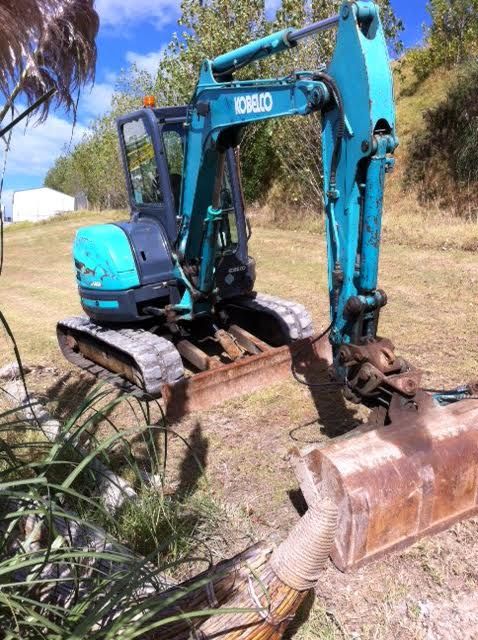 A blue excavator with the word kobelco on it