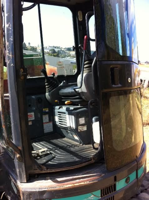 The inside of an excavator with the door open