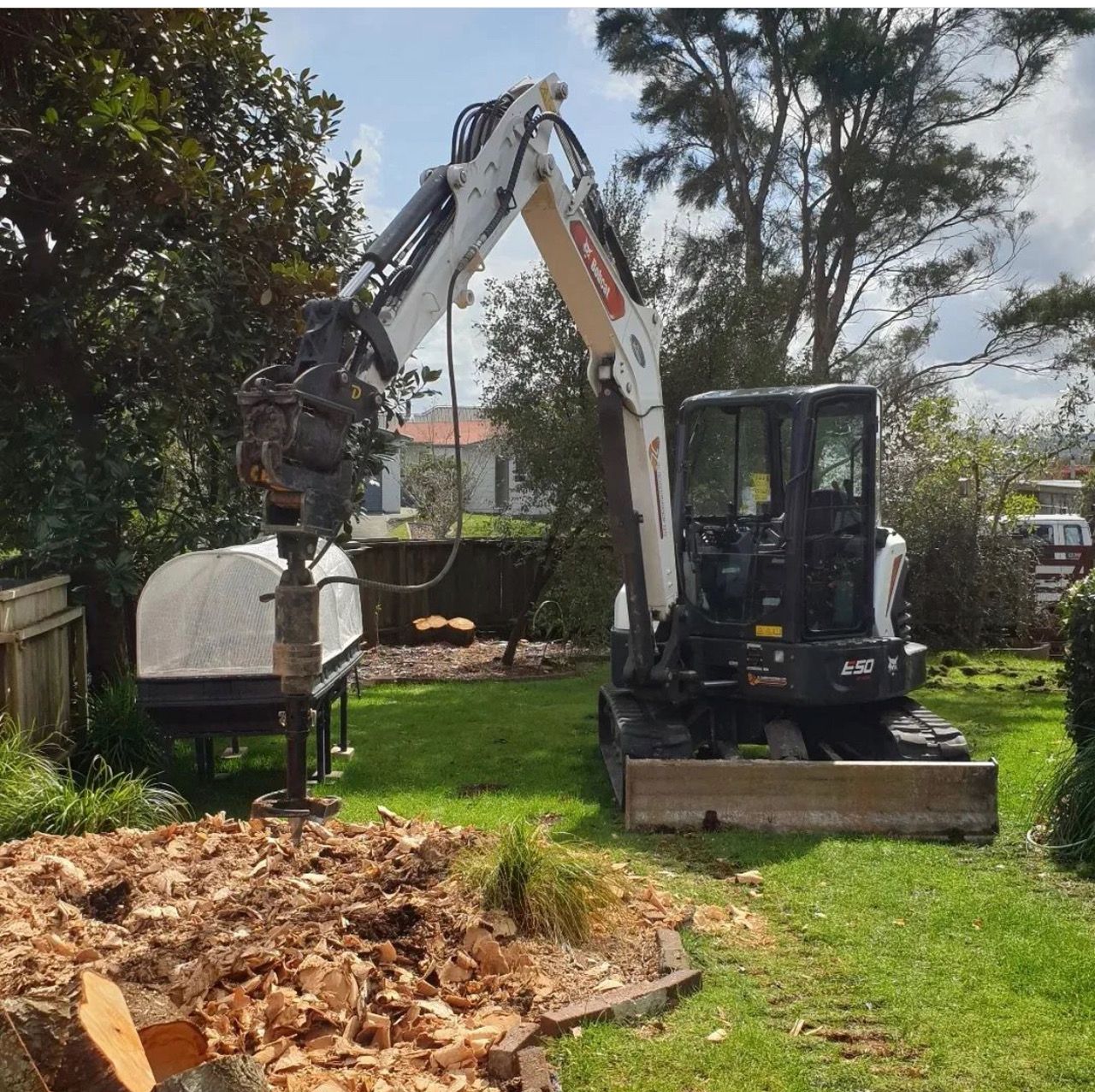 A bulldozer is being used to remove a tree stump