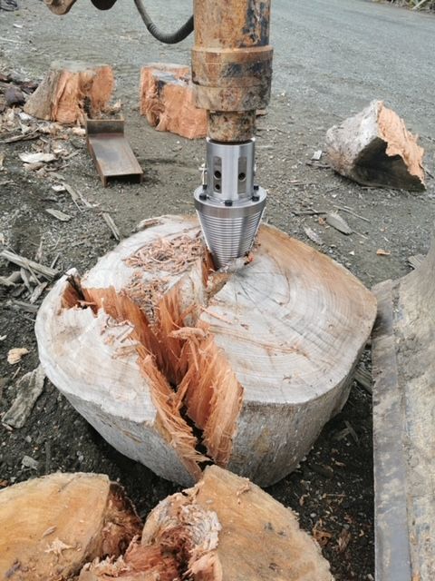 A machine is cutting a large piece of wood