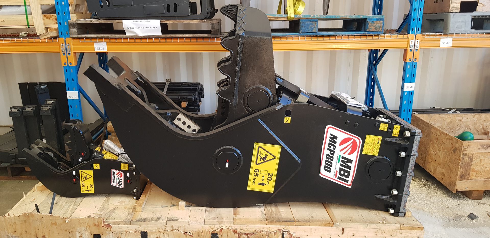 A machine is sitting on a wooden pallet in a warehouse.