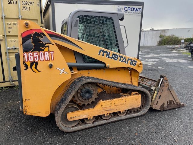 A mustang skid steer is parked in a parking lot
