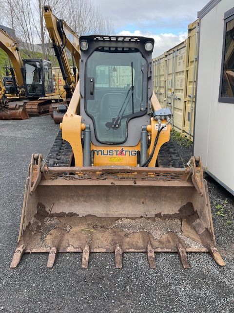 A mustang bulldozer is parked in a parking lot