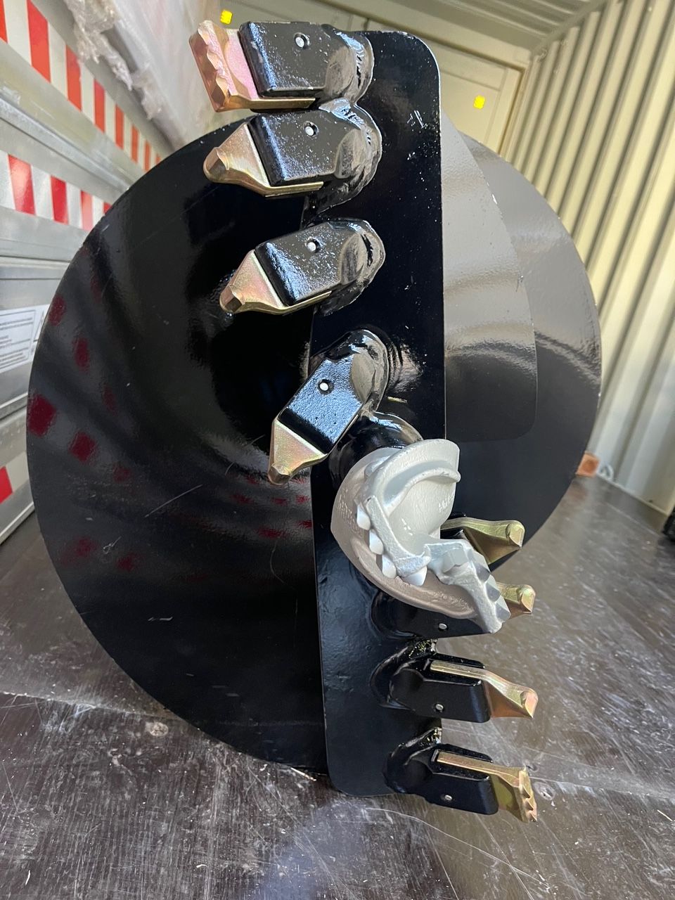 A close up of a black object sitting on top of a wooden floor.