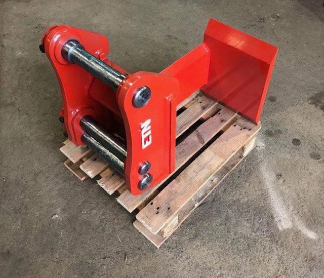 A red etm item is sitting on a wooden pallet