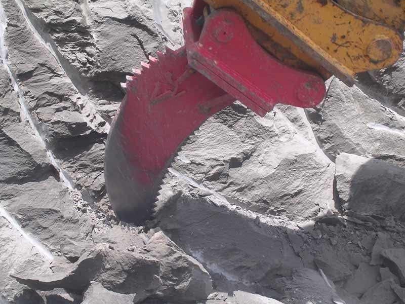 A close up of a red object on a rocky surface