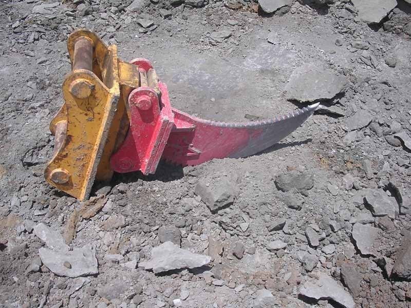 A red and yellow piece of equipment is laying on the ground