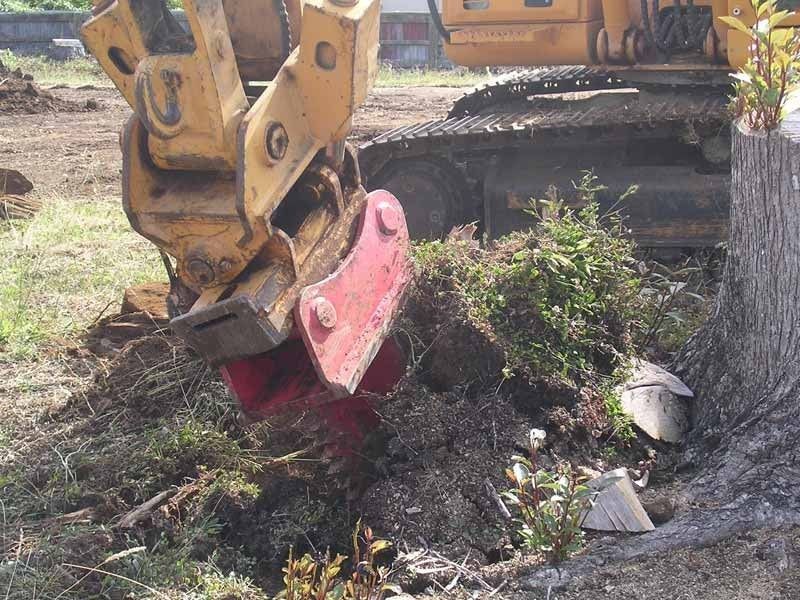 A yellow bulldozer is digging a hole in the ground