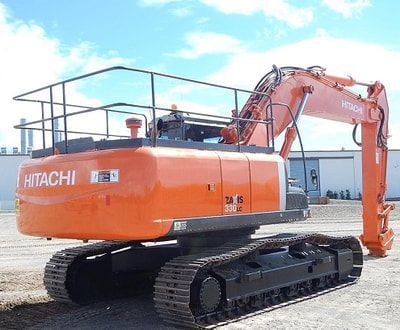 A hitachi excavator is parked in a parking lot.