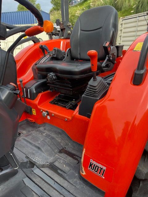 A red tractor with the word kubota on the side