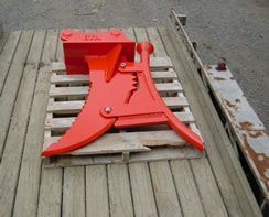 A red object is sitting on top of a wooden pallet.