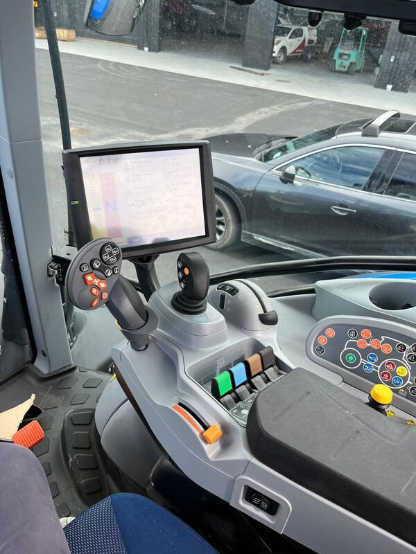 The inside of a tractor with a monitor and controls